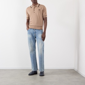 Model wearing Wales Bonner camel mohair wool polo with contrast tipping, styled with light wash jeans and dark loafers.