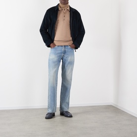 Model wearing Wales Bonner camel mohair wool polo, styled with dark navy bomber jacket, light wash straight-leg jeans and black loafers.