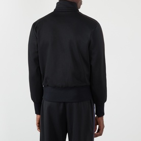 Model wearing Wales Bonner Form Logo Zip Track Sweatshirt in black, back view, showing ribbed trims, straight hem and tonal panel detail