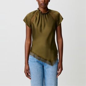 Model wearing Claude Pierlot brown satin top with ruched high neck, cap sleeves and lace-trimmed asymmetric hem, styled with blue jeans