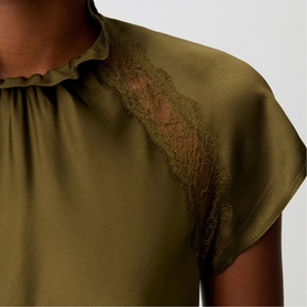 Model wearing Claude Pierlot Womens French Dress in brown, featuring lace shoulder detail and ruffled neckline on short-sleeve satin top.
