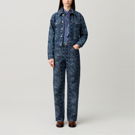 Model wearing Claude Pierlot navy print denim jacket and matching wide-leg trousers with all-over paisley pattern, styled with brown shoes.