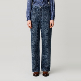 Model wearing Claude Pierlot navy print wide-leg trousers with paisley pattern, styled with a blue printed blouse and brown loafers.