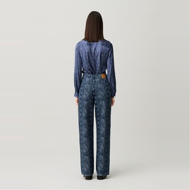 Model wearing Claude Pierlot navy print wide-leg jeans, styled with a matching navy print long-sleeve blouse, rear view.