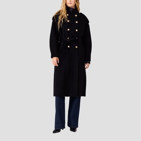Model wearing Maje red double-breasted long coat with gold buttons and belt, styled with navy wide-leg trousers