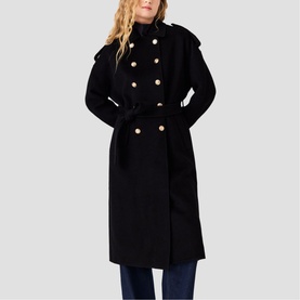 Model wearing Maje red double-breasted belted long coat with gold buttons, styled with blue jeans