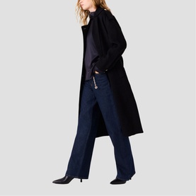 Model wearing Maje Womens French Dress in red, styled with dark wide-leg jeans and black pointed-toe heels