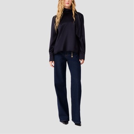 Model wearing Maje navy turtleneck top with sheer sleeves, styled with wide-leg dark navy trousers and black heels