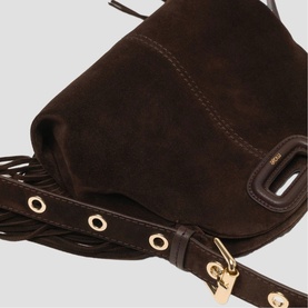 Maje dark brown suede bag close-up showing fringe detail, gold-tone eyelet trim, and adjustable shoulder strap.