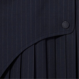 Claude Pierlot Womens French Dress in black pinstripe fabric, close-up detail showing pleated panel and button fastening.