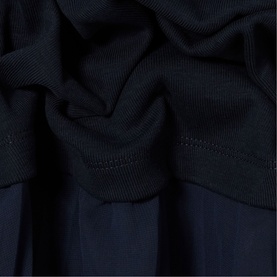 Claude Pierlot blue womenswear fabric close-up showing ribbed knit texture and draped folds in navy blue tone