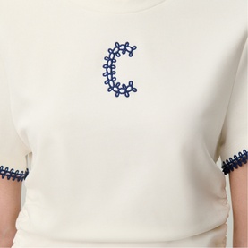 Claude Pierlot cream knit top with navy embroidered C logo and navy scallop-trim cuffs, cropped view