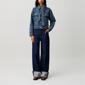 Model wearing Claude Pierlot navy print denim jacket with paisley pattern, styled with wide-leg dark rinse jeans and grey mules