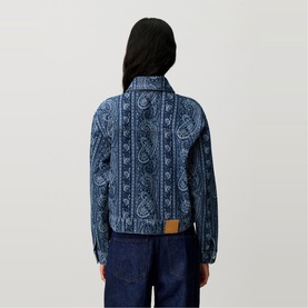 Model wearing Claude Pierlot navy print paisley denim jacket, rear view, styled with dark wide-leg jeans and tan belt.