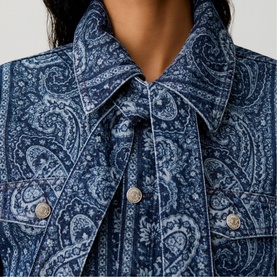 Model wearing Claude Pierlot Womens French Dress in navy paisley print, showing pointed collar and silver button detail at neckline