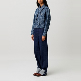 Model wearing Claude Pierlot navy print denim jacket with paisley pattern, styled with matching wide-leg dark denim trousers and brown loafers