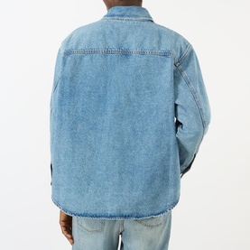 Model wearing AMI Bleu Used denim casual jacket, rear view showing relaxed fit and classic collar detail