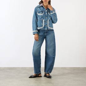 Model wearing AgoldE proof-wash barrel-leg jeans with matching denim jacket, black flat loafers, full-length front view