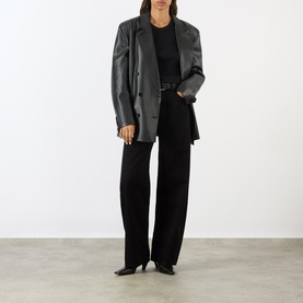 Model wearing AgoldE Logical wide-leg jeans in black, styled with a grey leather blazer and black heeled boots.