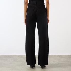 Model wearing AgoldE wide-leg black jeans, rear view, high-rise fit with clean finish and relaxed straight leg silhouette.