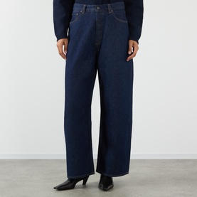 Model wearing AgolдE rinse wide-leg jeans in dark indigo denim, styled with black heeled boots and dark top.