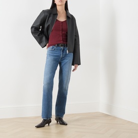 Model wearing AgoldE straight jeans in waive blue denim, styled with black leather jacket, burgundy top and black heeled ankle boots