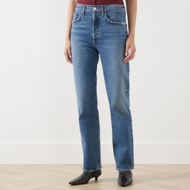 Model wearing AgoldE Straight jeans in waive blue denim, styled with black ankle boots. High-rise fit with classic five-pocket design.