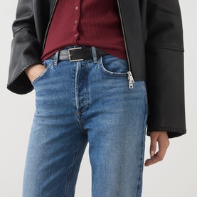 Model wearing AgoldE straight-leg jeans in waive blue denim, styled with a black leather jacket and burgundy ribbed top.
