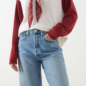 Model wearing AgoldE Straight Jeans in Outbreak light blue denim, styled with a red varsity sweatshirt and red bandana