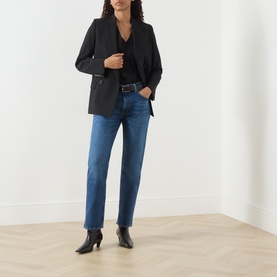 Model wearing Citizens of Humanity Slim Jeans in cruise blue, styled with a black blazer, black top and black ankle boots.