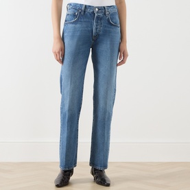 Model wearing Citizens of Humanity straight jeans in pastis blue denim, styled with black ankle boots. High-waisted with classic five-pocket design.