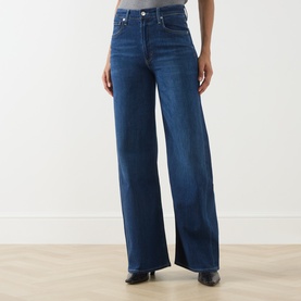 Model wearing Citizens of Humanity Wide Leg jeans in elm, high-rise with a relaxed wide-leg silhouette in dark blue denim