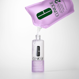 Clinique Take The Day Off Micellar Cleansing Water with refill pouch pouring into glass bottle, purple packaging