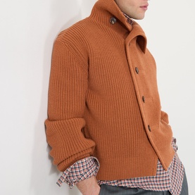Model wearing Dries Van Noten Marino Rib-Knit Cardigan in Ocra, ribbed wool with funnel neck and front buttons, styled with checked shirt.