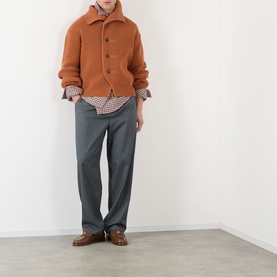 Model wearing Dries Van Noten Marino Rib-Knit Cardigan in Ocra, styled with check shirt and grey trousers