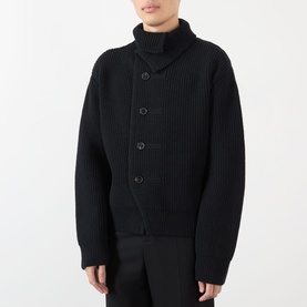 Model wearing Dries Van Noten black wool cardigan with shawl collar, ribbed knit texture and button front fastening.