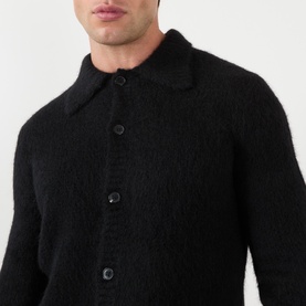 Model wearing Dries Van Noten Mora Brushed Knitted Cardigan in black, showing polo collar and front button fastening detail