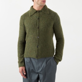 Model wearing Dries Van Noten Mora Brushed Knitted Cardigan in Forest Green with polo collar and button front, styled with grey trousers.