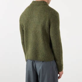 Model wearing Dries Van Noten Mora Brushed Knitted Cardigan in Forest Green, back view, styled with grey trousers.