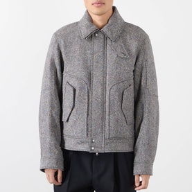 Model wearing Dries Van Noten black wool casual jacket with spread collar, zip front, and large front pockets