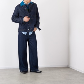 Model wearing Dries Van Noten Indigo Cotton Casual Jacket, styled with wide-leg navy trousers and a blue shirt.