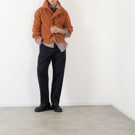 Model wearing Dries Van Noten red cotton casual shirt, styled with rust wool jacket, black trousers and black leather shoes.