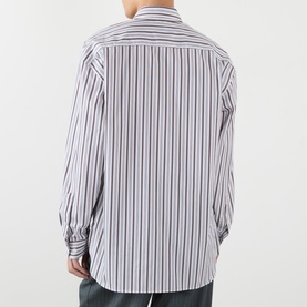 Model wearing Dries Van Noten Croom Striped Shirt in white, back view, showing dropped shoulders, long sleeves and buttoned cuffs