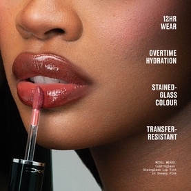 Model wearing MAC Lipterglass Stained-Glass Lip Tint in shade Posh Pit, a deep berry gloss with high-shine finish