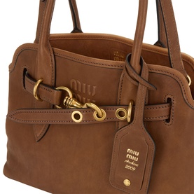 Miu Miu Rovere brown calfskin leather crossbody bag with gold-tone hardware, dual top handles and branded luggage tag detail.