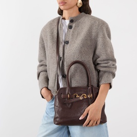 Model carrying Miu Miu Aventure Aviator Medium Bag in Radica leather with gold-tone hardware and belt clasp, worn crossbody. Styled with grey knit