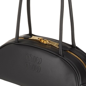 Miu Miu Beau Softy Logo Bag in black leather with gold-toned zip and hardware, embossed logo detail, and twin top handles.
