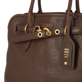 Miu Miu tote bag in Radica brown lambskin with gold-tone hardware, dual top handles and branded charm tag detail.