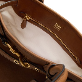 Miu Miu Rovere lambskin tote bag interior view, cream lining, gold-tone zip pocket and hardware detail visible