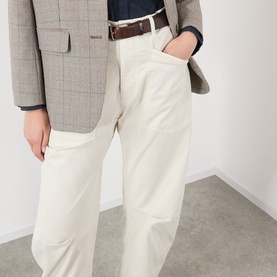 Model wearing Nili Lotan stone wide-leg trousers with brown belt, styled with navy top and grey check blazer.